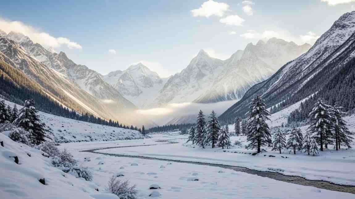 Snow-covered valley with flowing river and pine trees in Yumthang, among the best places to visit in North East India during winter
